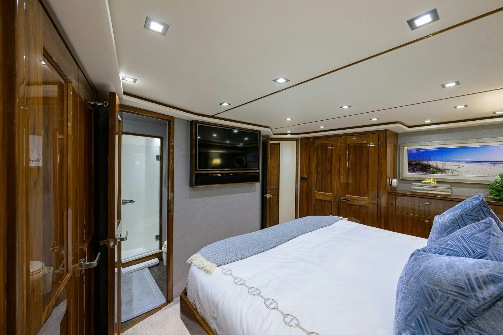 a bedroom with a bed and a television on the wall aboard BACCHUS Yacht for Sale