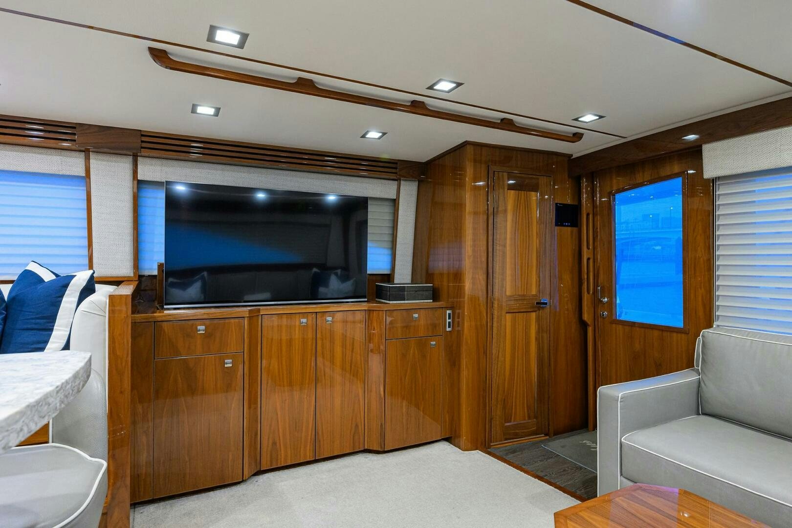 a living room with a tv and couches aboard BACCHUS Yacht for Sale