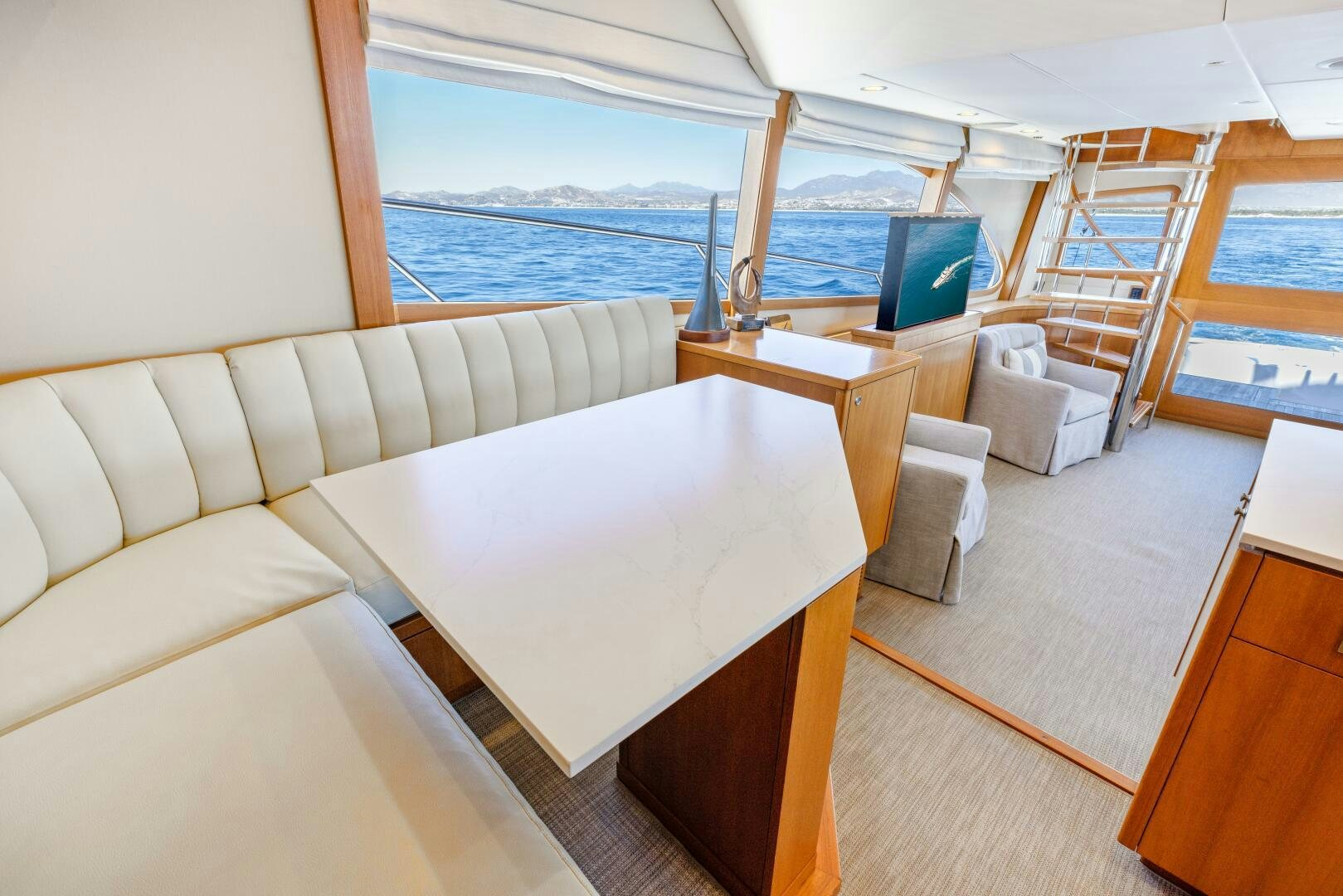 a room with a couch and a table and a tv aboard SALTY K Yacht for Sale