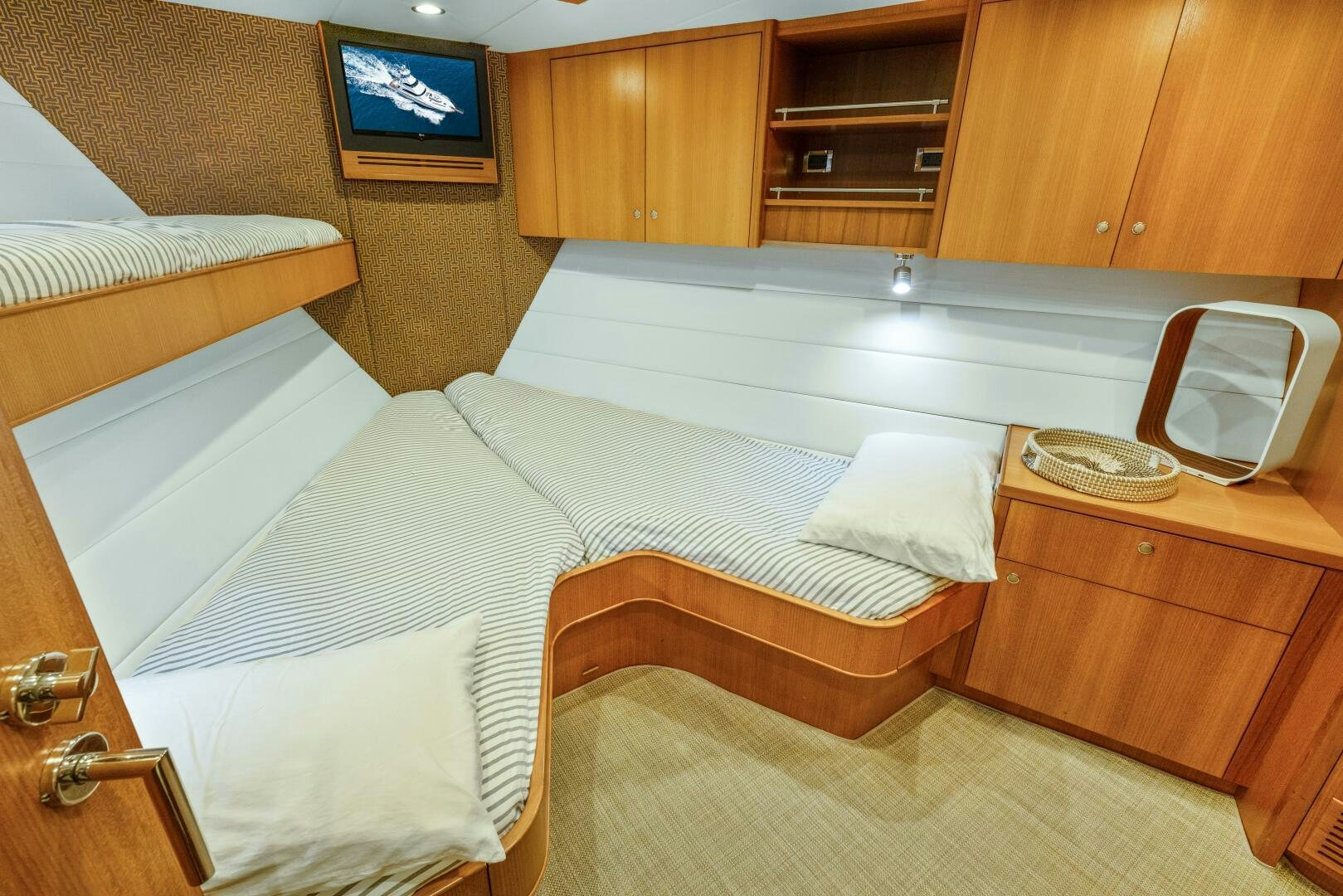 a room with a bed and a television aboard SALTY K Yacht for Sale