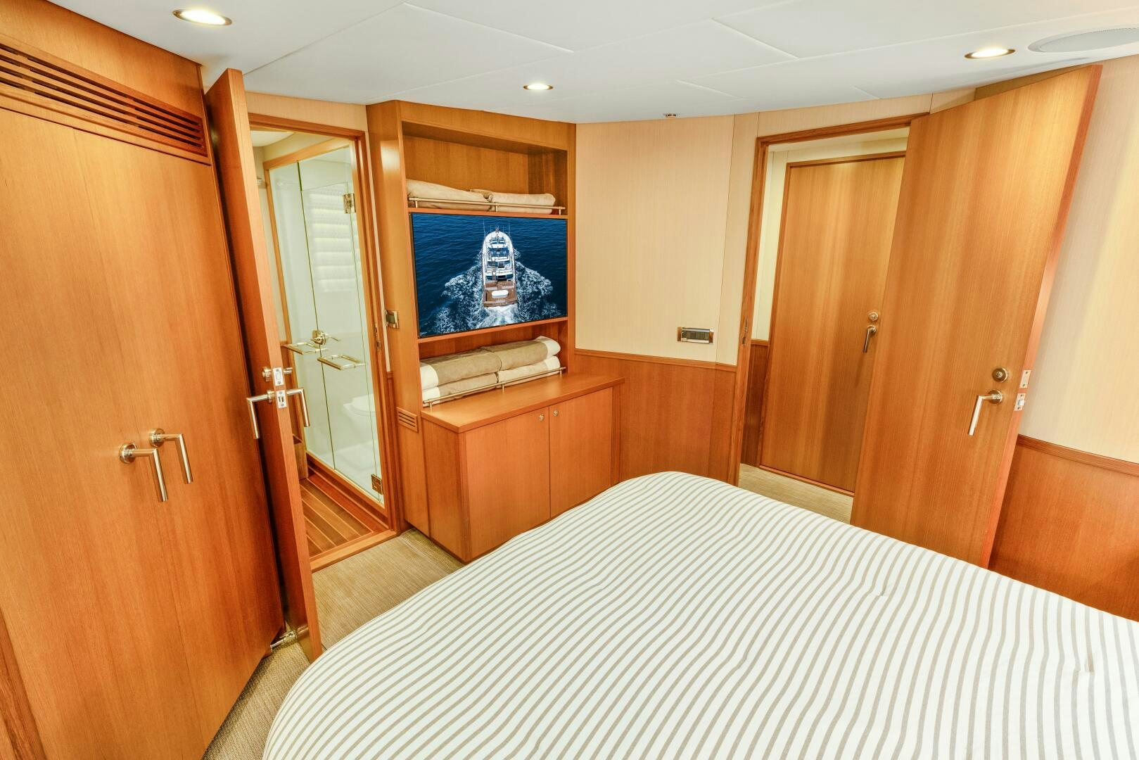 a bedroom with a bed and a television aboard SALTY K Yacht for Sale