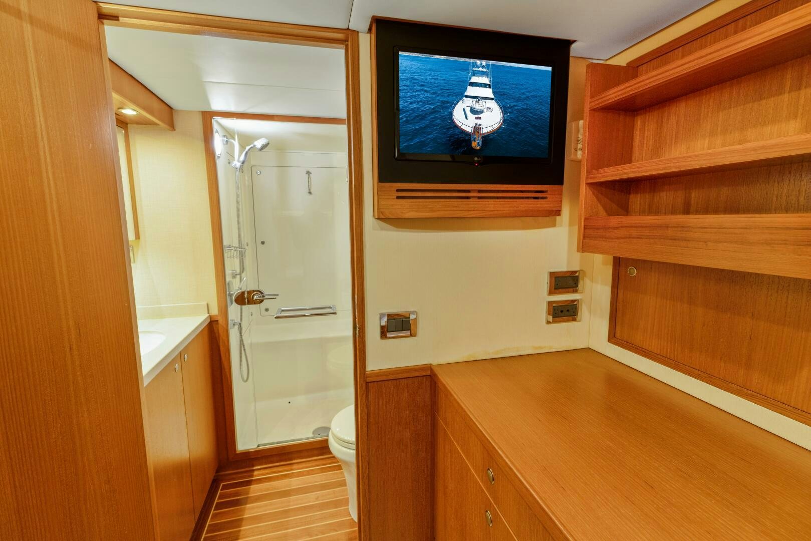 a room with a tv and a wood cabinet aboard SALTY K Yacht for Sale