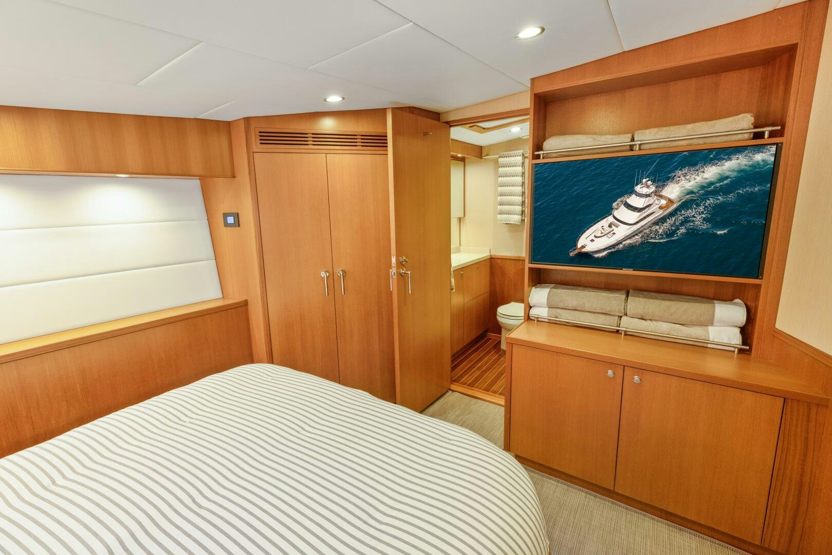 a bedroom with a bed and a desk aboard SALTY K Yacht for Sale