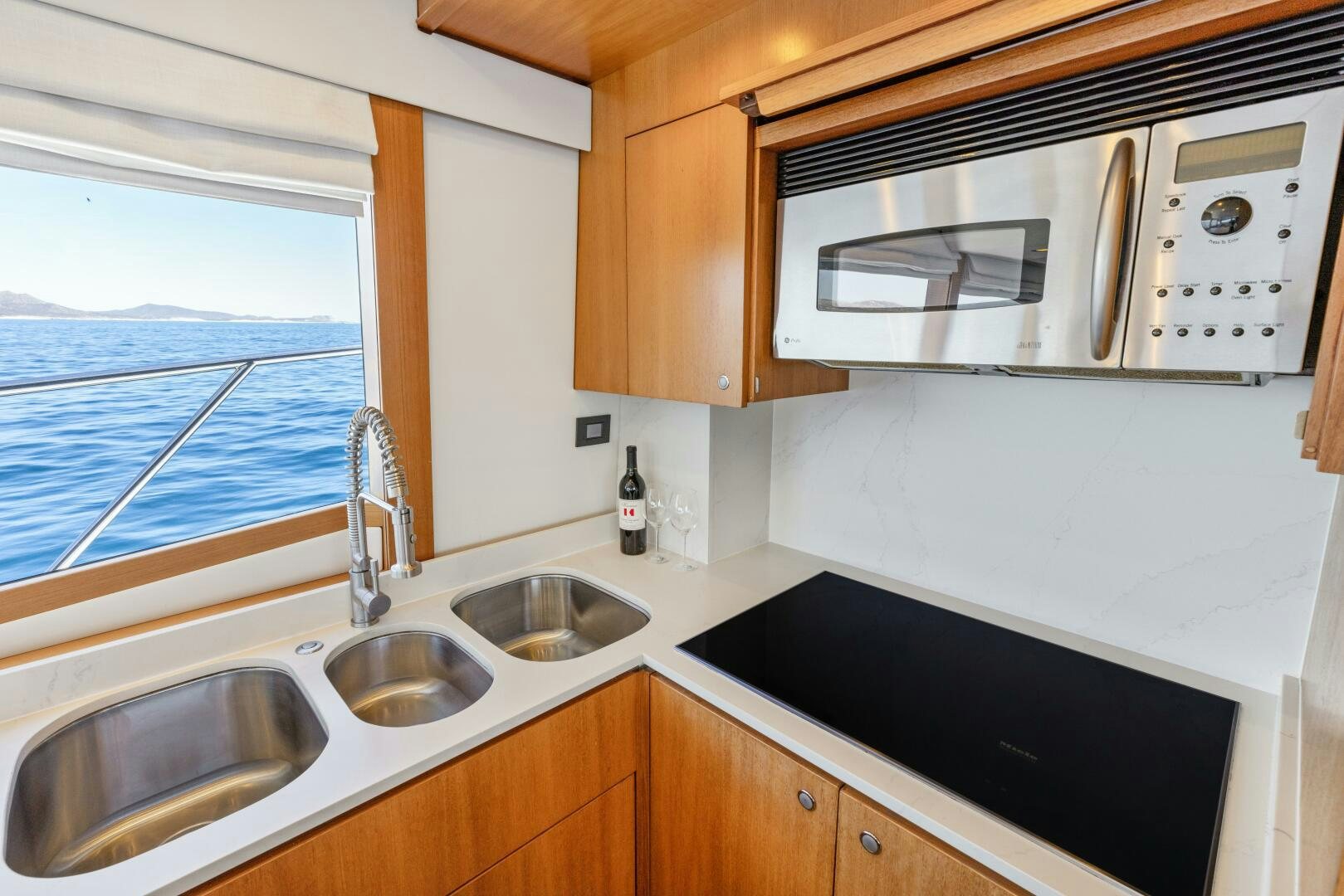 a kitchen with a microwave oven aboard SALTY K Yacht for Sale