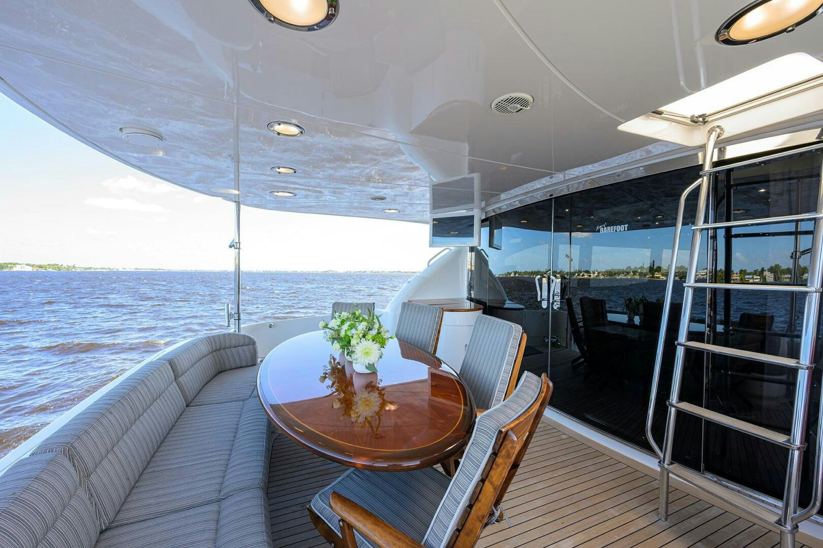 a boat with a table and chairs aboard ALWAYS BAREFOOT Yacht for Sale
