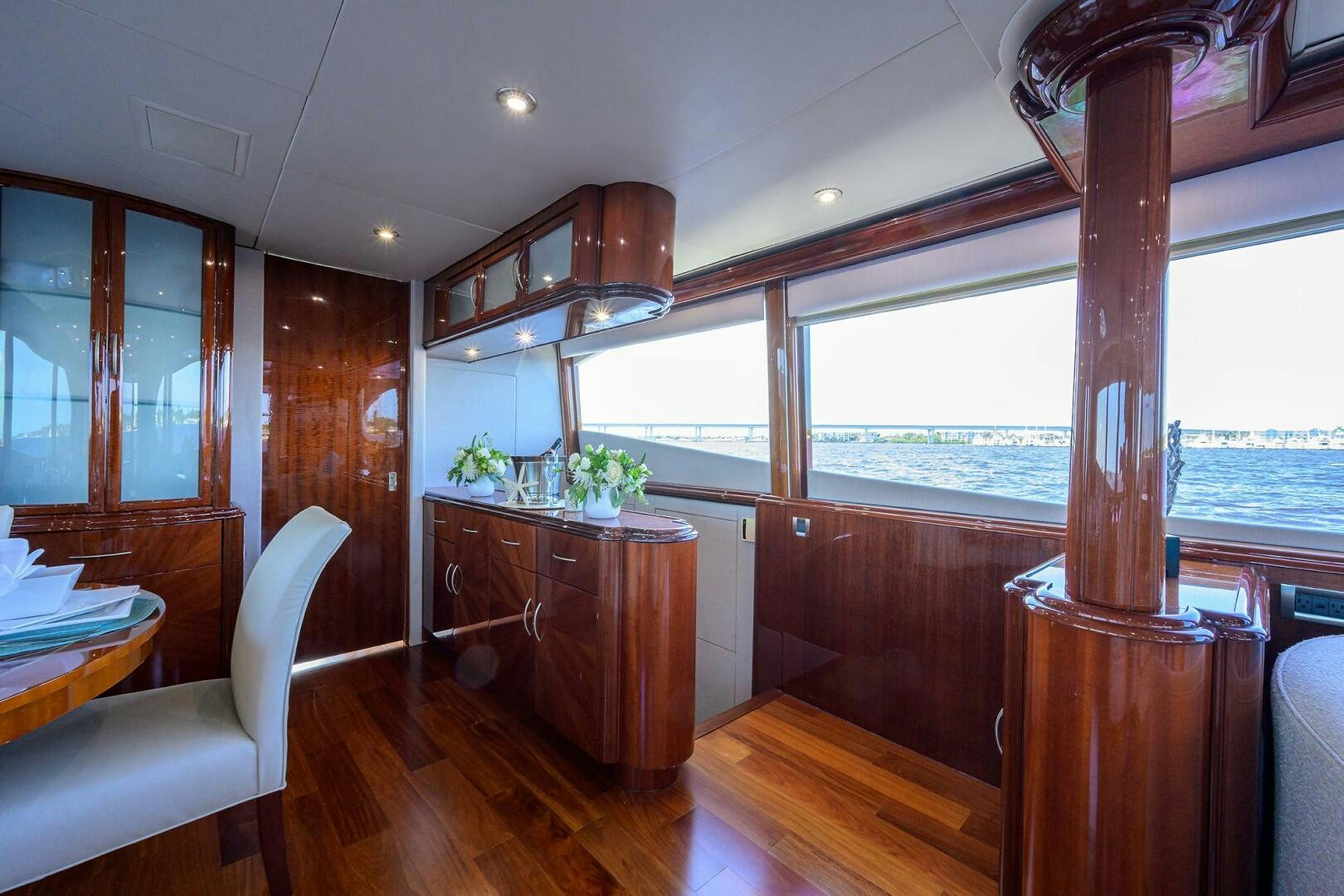 a room with a wood table and a large window aboard ALWAYS BAREFOOT Yacht for Sale
