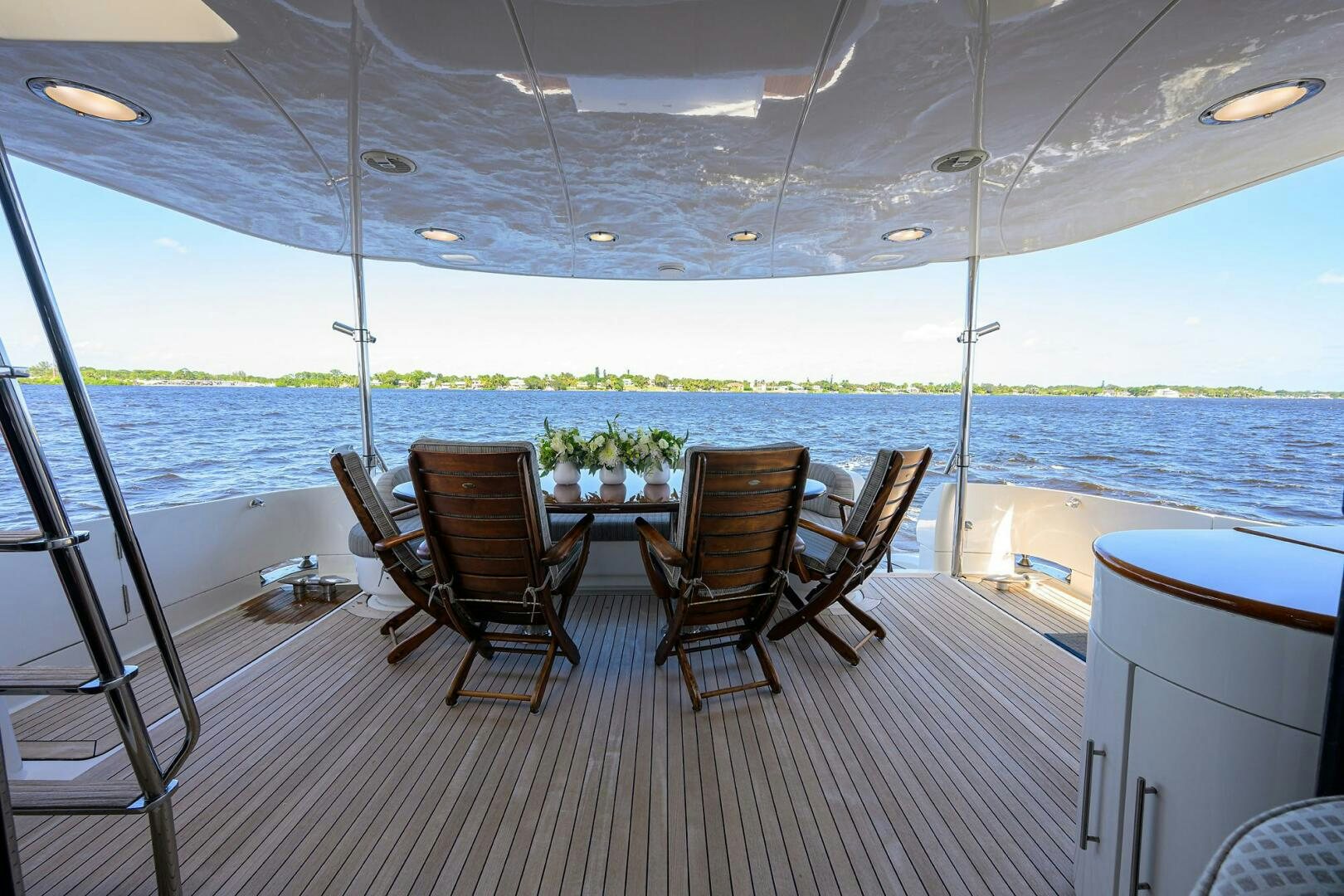 a deck with chairs and a table on it aboard ALWAYS BAREFOOT Yacht for Sale
