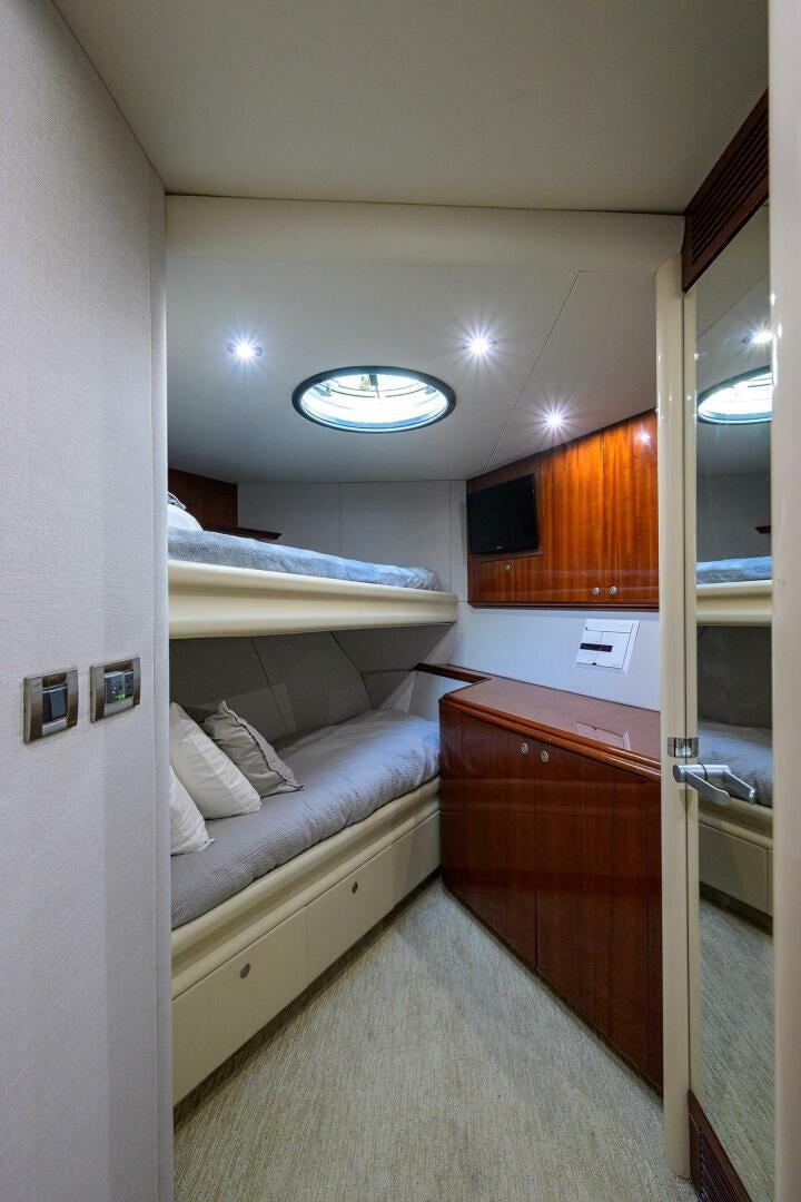 a bedroom with a bed and a dresser aboard ALWAYS BAREFOOT Yacht for Sale