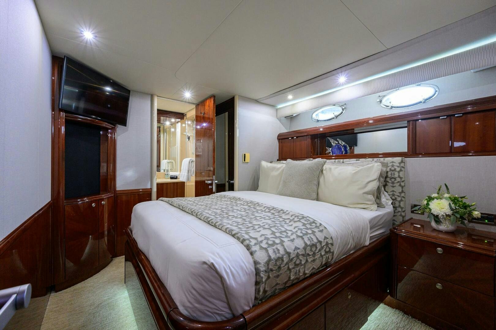 a bedroom with a bed and a dresser aboard ALWAYS BAREFOOT Yacht for Sale