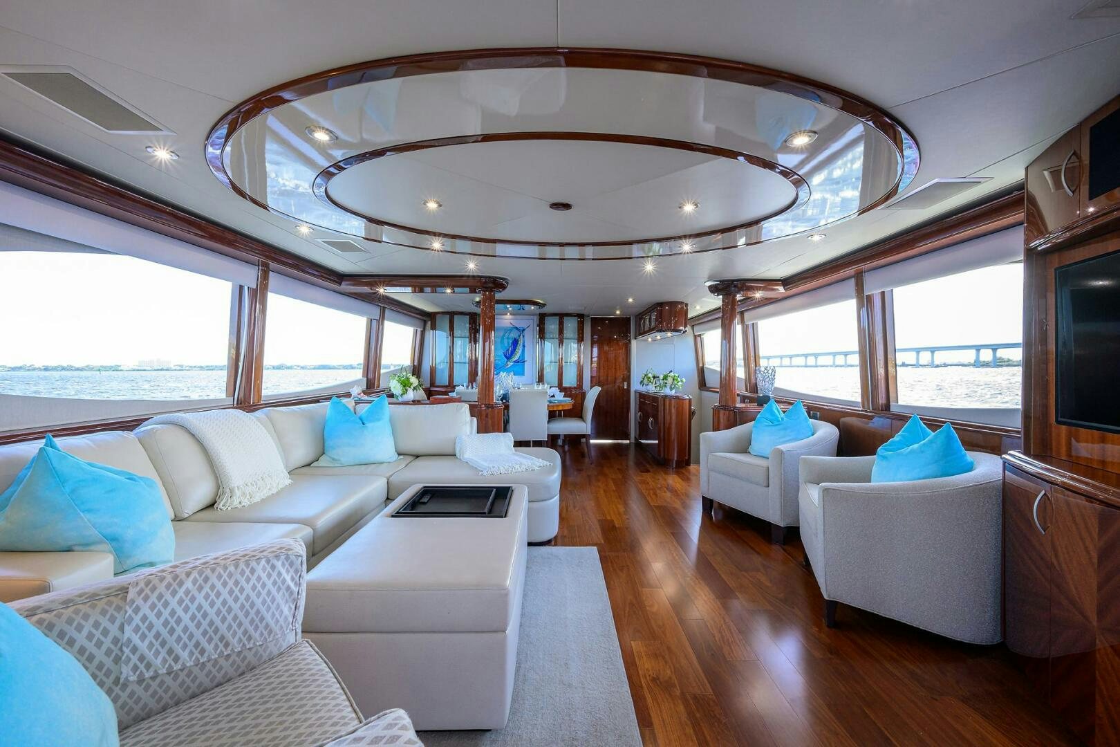 a large living room with a large chandelier aboard ALWAYS BAREFOOT Yacht for Sale