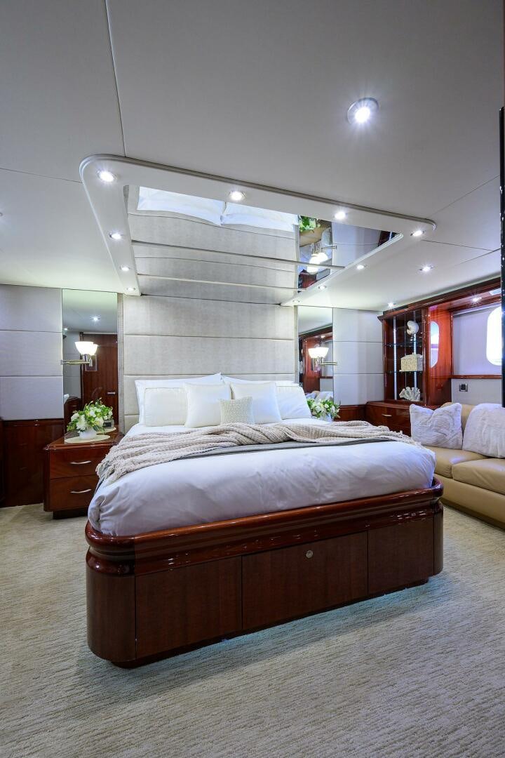 a bedroom with a large mirror aboard ALWAYS BAREFOOT Yacht for Sale