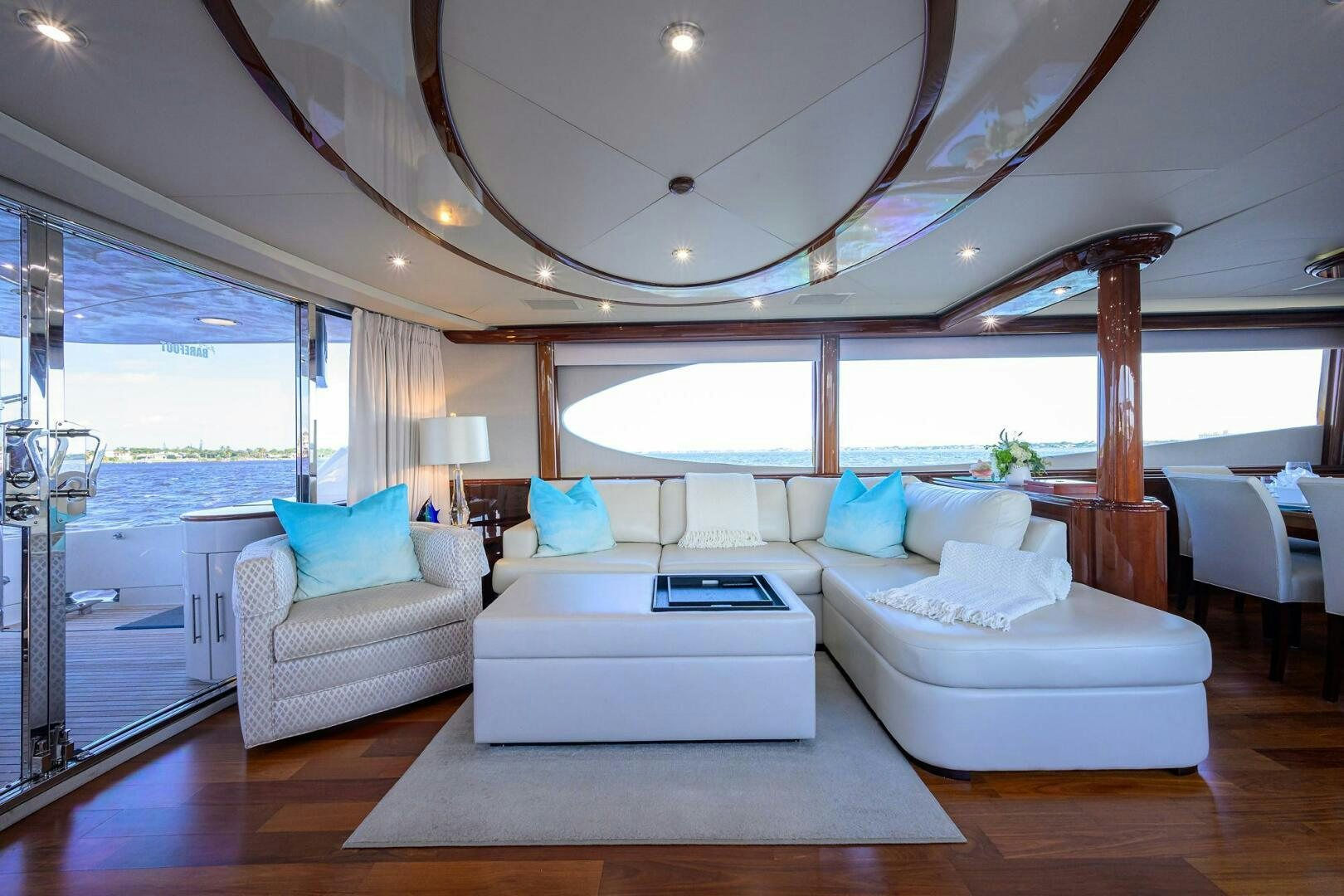 a room with a large white bed and a large window aboard ALWAYS BAREFOOT Yacht for Sale