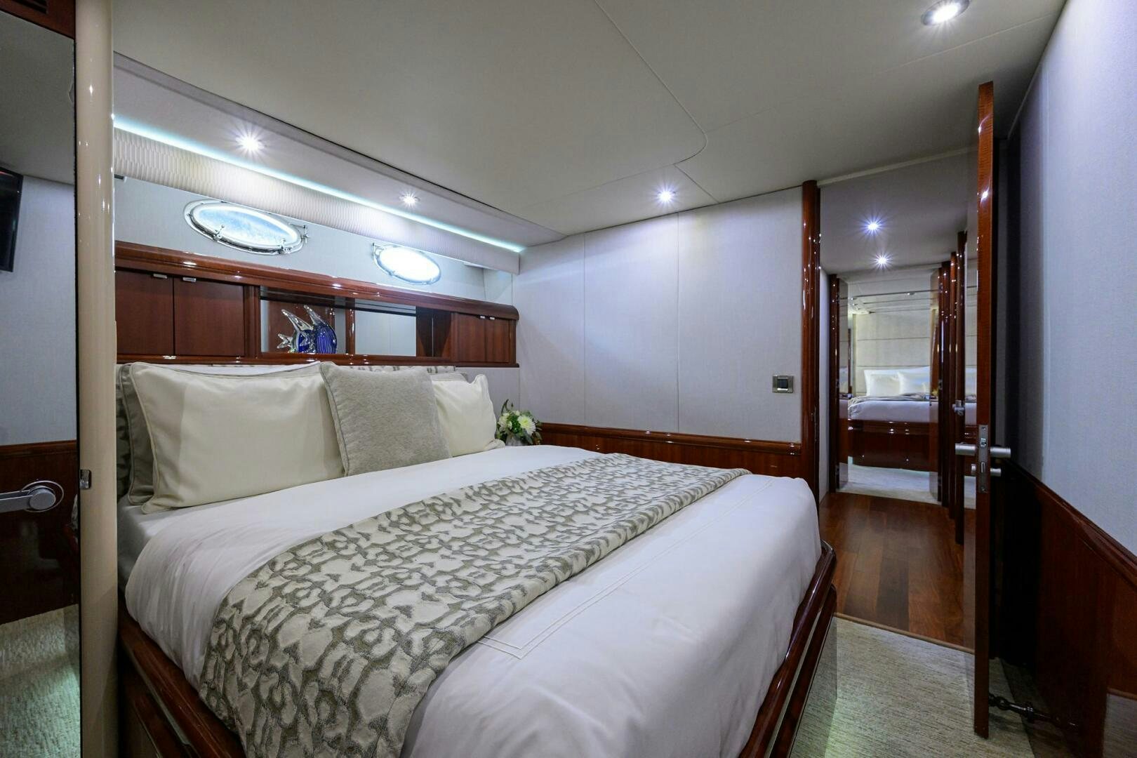 a bedroom with a bed and a wood door aboard ALWAYS BAREFOOT Yacht for Sale