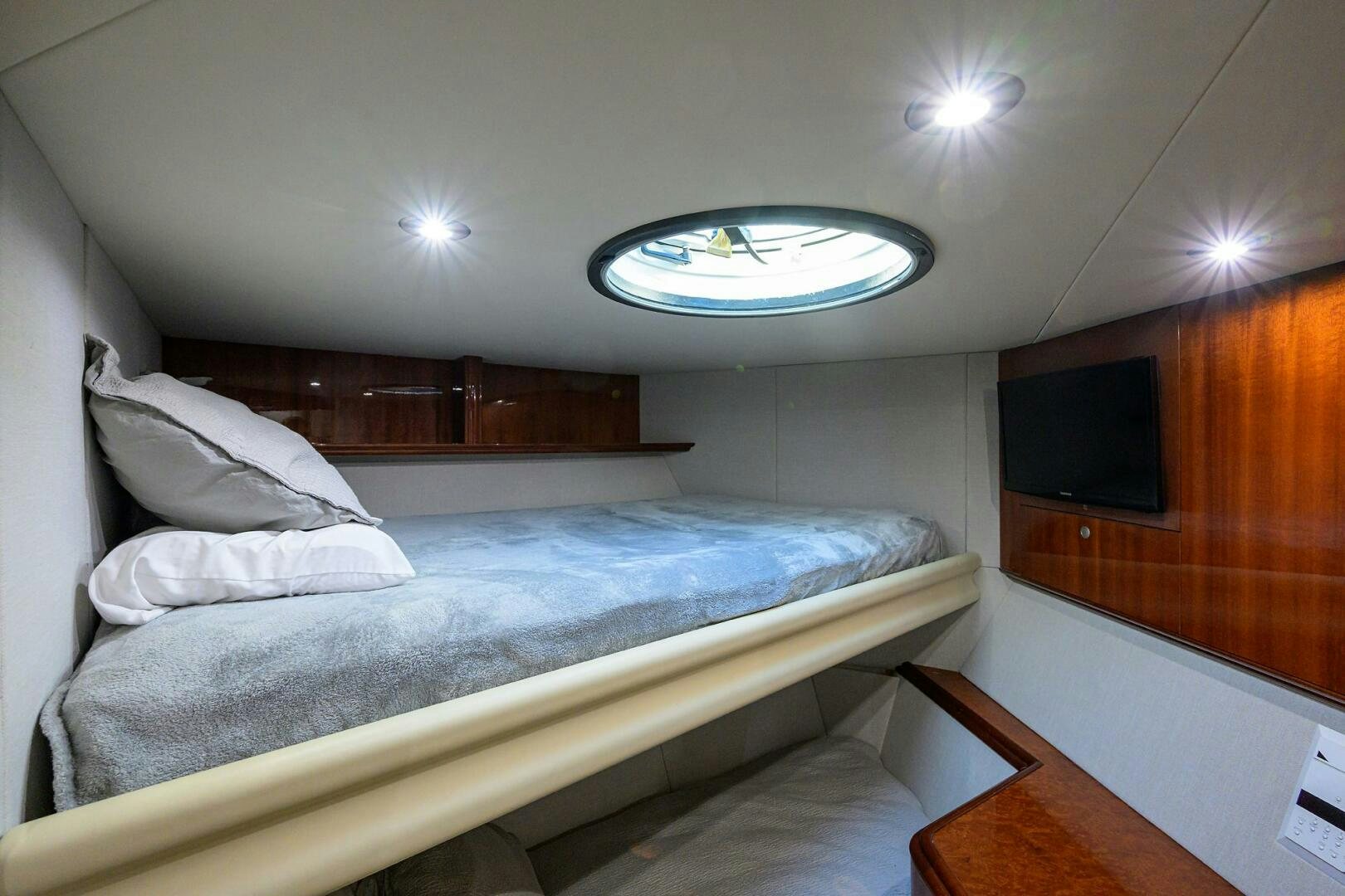 a room with a bed and a television aboard ALWAYS BAREFOOT Yacht for Sale