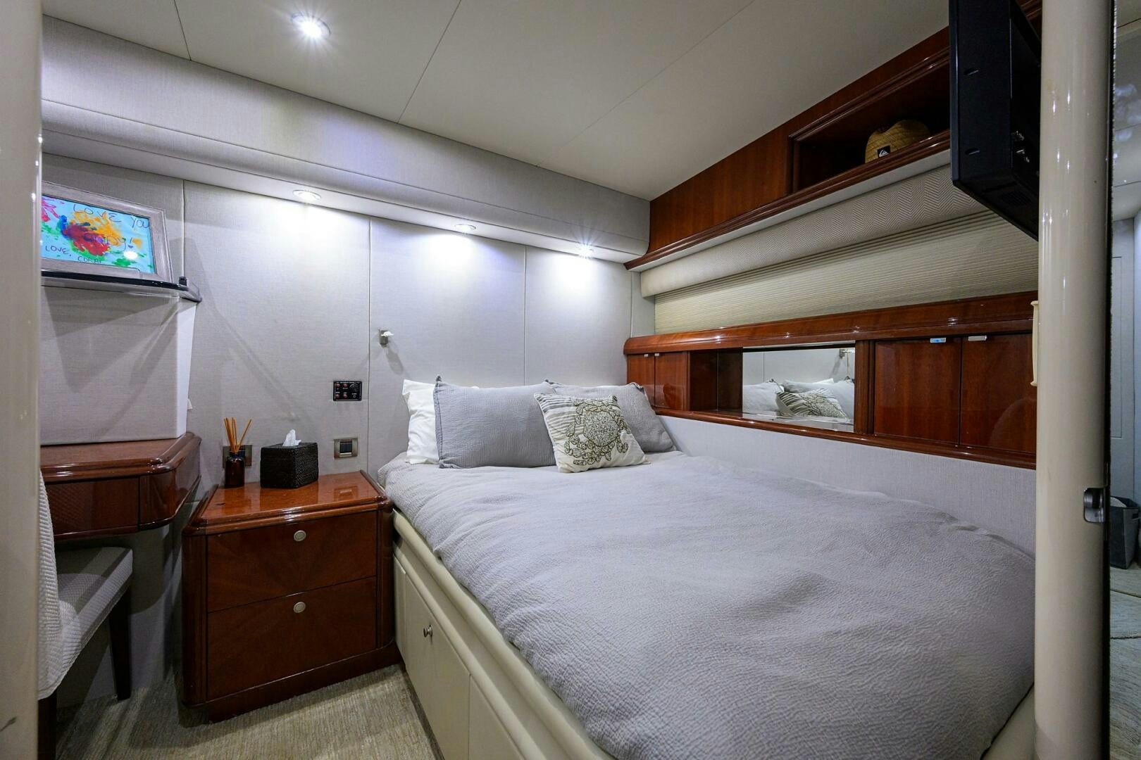 a bedroom with a bed and a television aboard ALWAYS BAREFOOT Yacht for Sale