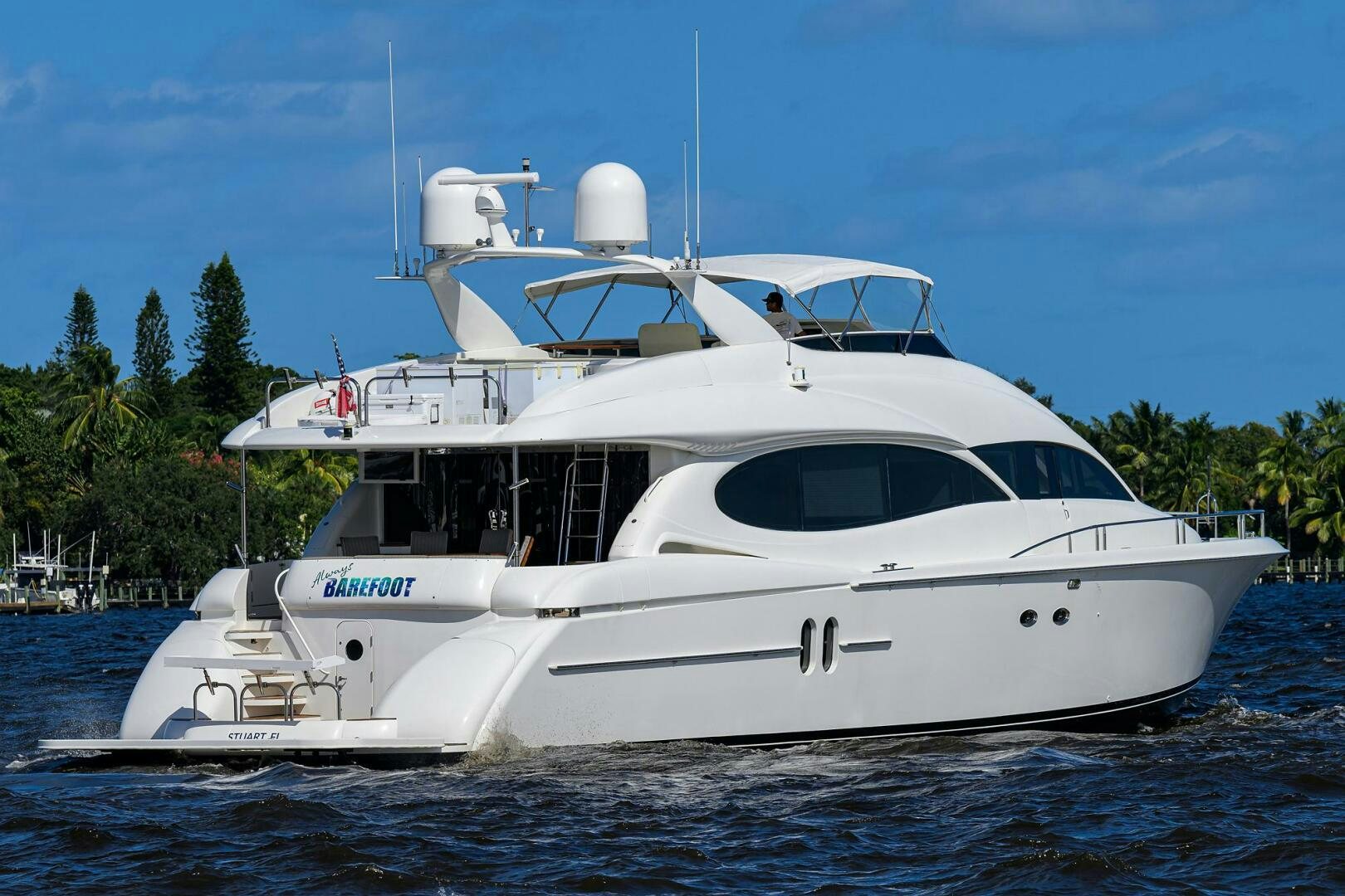 a white yacht on the water aboard ALWAYS BAREFOOT Yacht for Sale