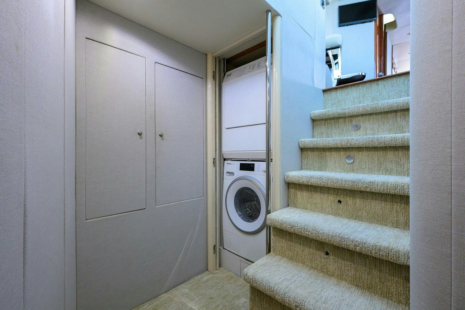 a white laundry room with a washer and dryer aboard ALWAYS BAREFOOT Yacht for Sale