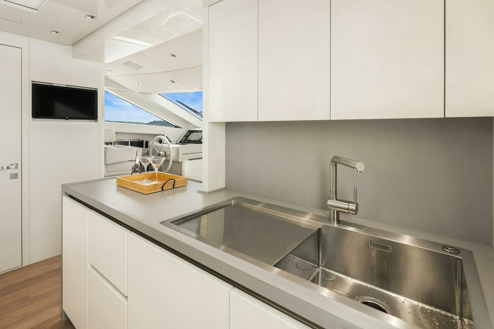 a kitchen with white cabinets aboard SANLORENZO SL86 Yacht for Sale