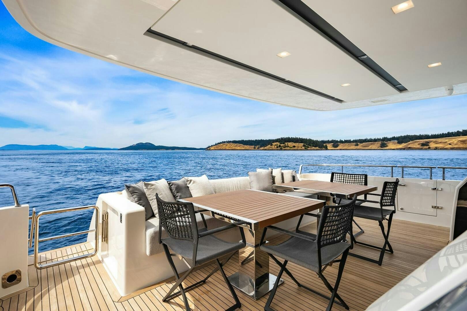 a table and chairs on a deck overlooking a body of water aboard SANLORENZO SL86 Yacht for Sale