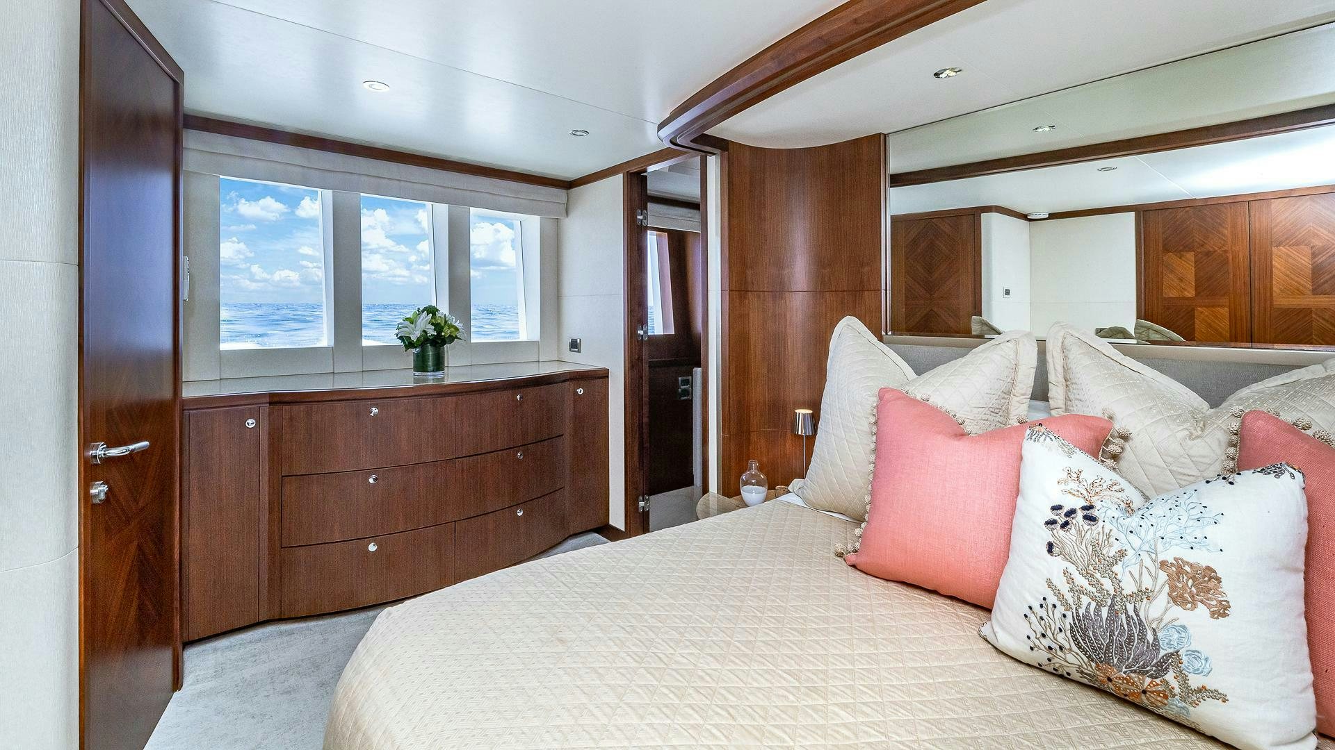 a bed with pillows and a dresser aboard NOW WE KNOW Yacht for Sale