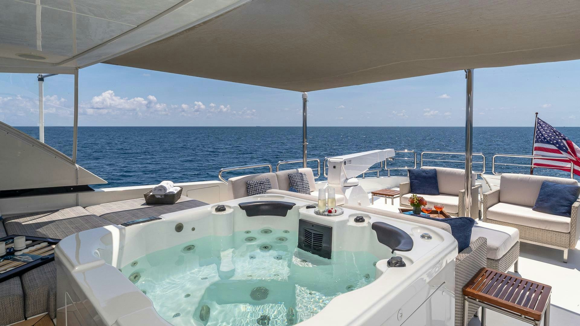 a large white boat with a blue and white striped pillow on it aboard NOW WE KNOW Yacht for Sale