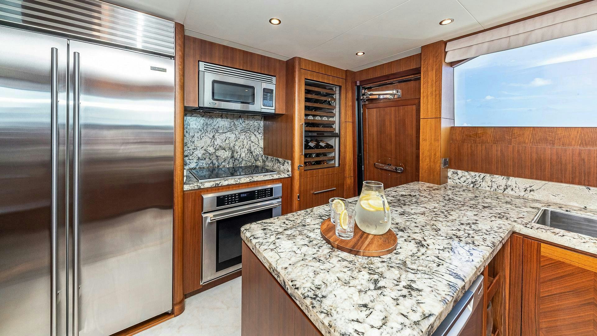 a kitchen with a stainless steel refrigerator aboard NOW WE KNOW Yacht for Sale