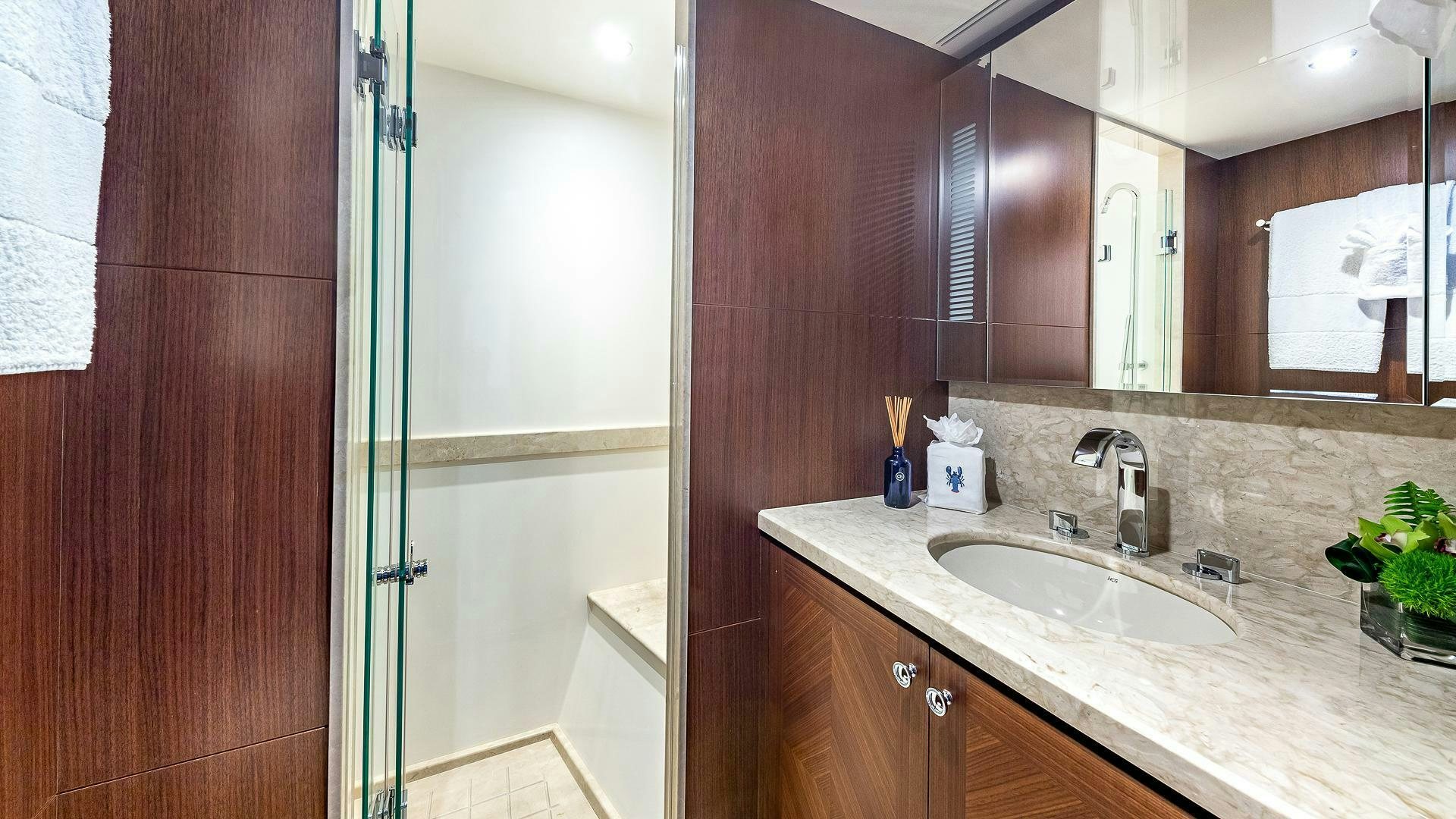 a bathroom with a sink and a mirror aboard NOW WE KNOW Yacht for Sale