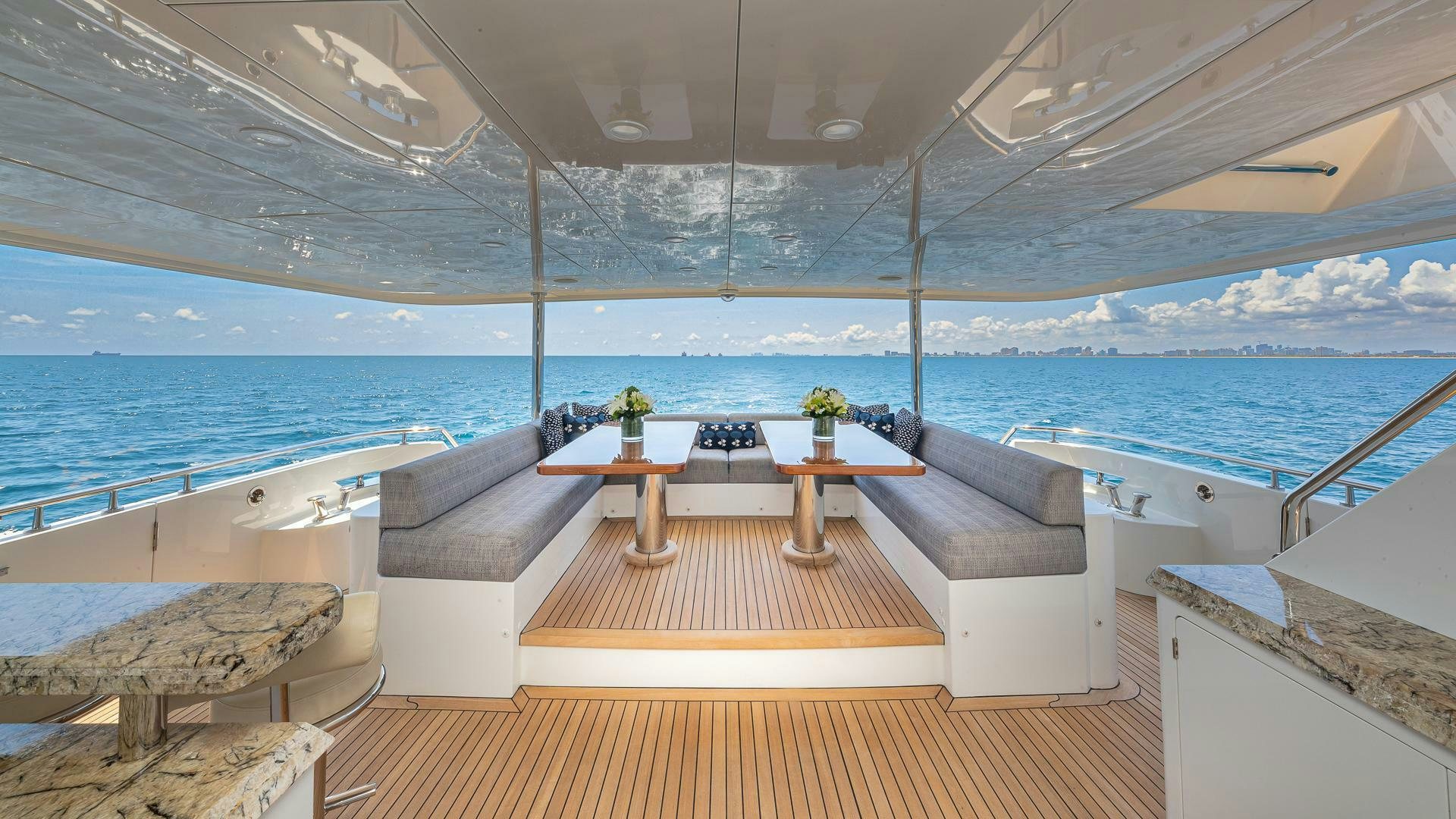 a room with a view of the ocean and a large pool aboard NOW WE KNOW Yacht for Sale