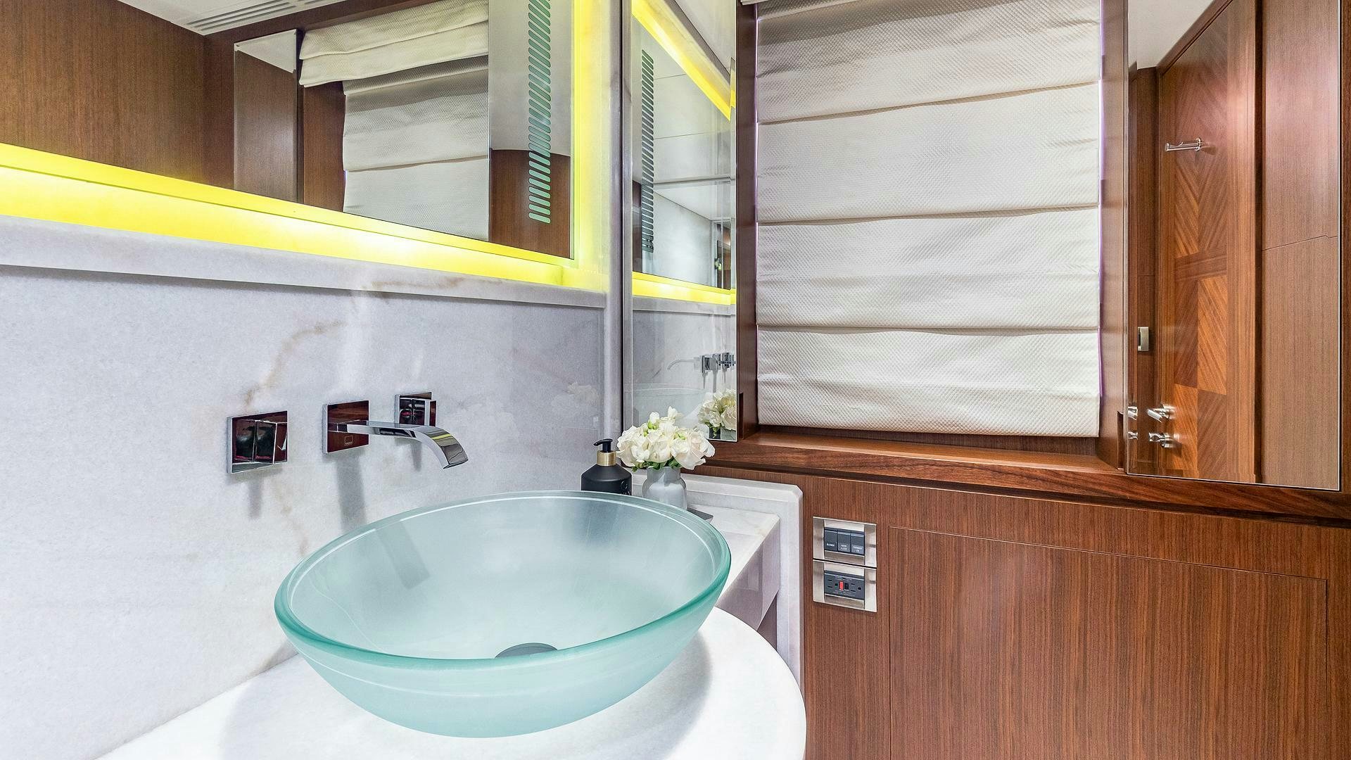 a bathroom with a sink and cabinets aboard NOW WE KNOW Yacht for Sale