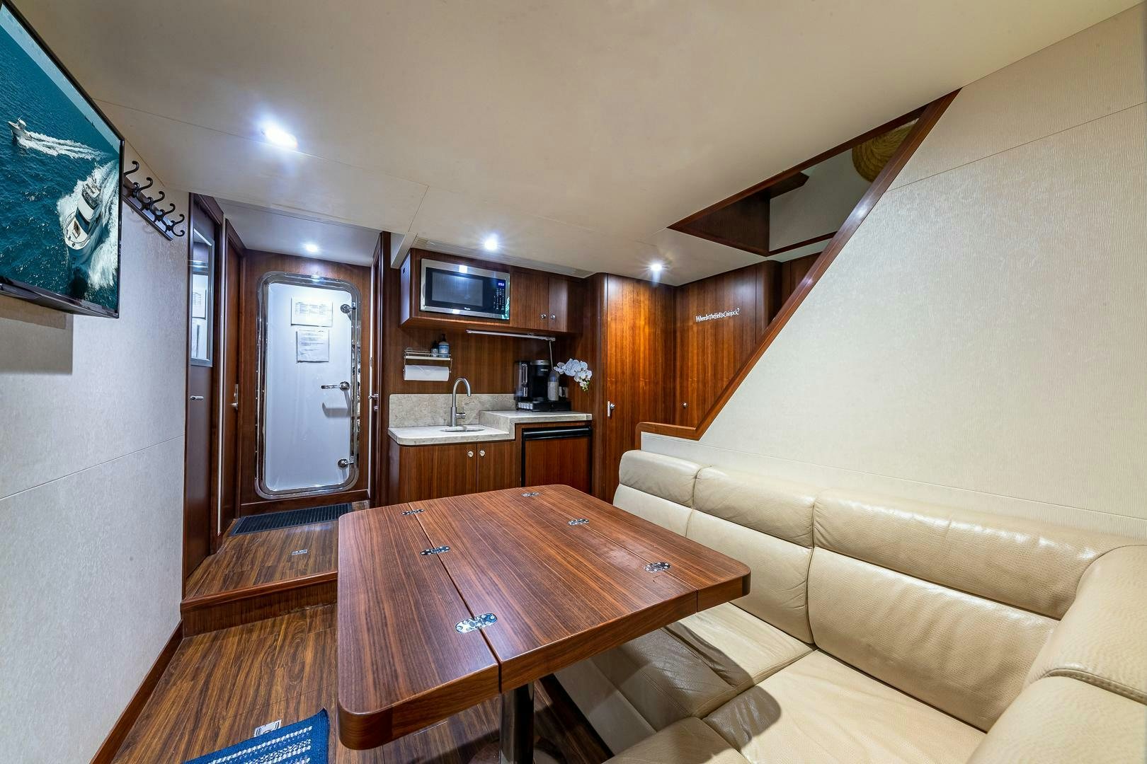a living room with a table and couches aboard NOW WE KNOW Yacht for Sale