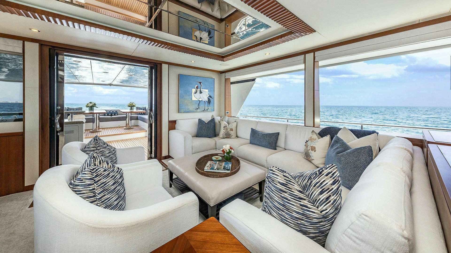 a living room with a large window aboard NOW WE KNOW Yacht for Sale