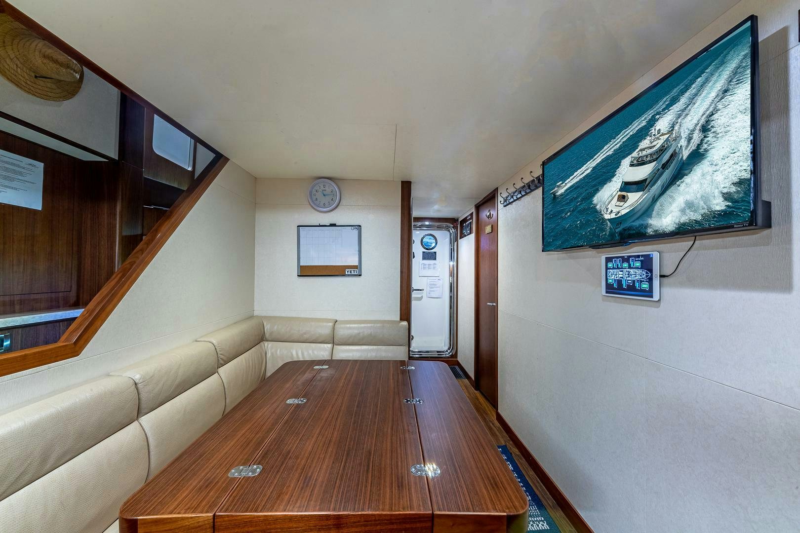 a room with a table and couch aboard NOW WE KNOW Yacht for Sale