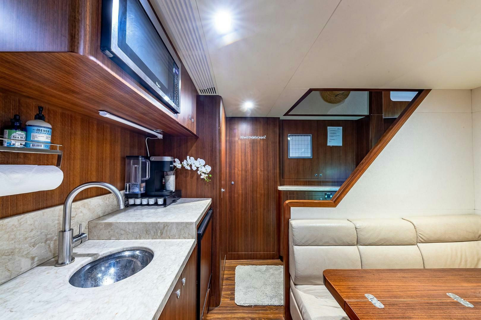 a kitchen with wooden cabinets aboard NOW WE KNOW Yacht for Sale