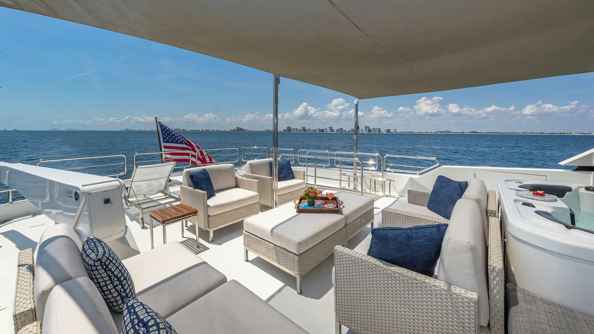 a large white lounge chair on a boat with a large body of water in the background aboard NOW WE KNOW Yacht for Sale