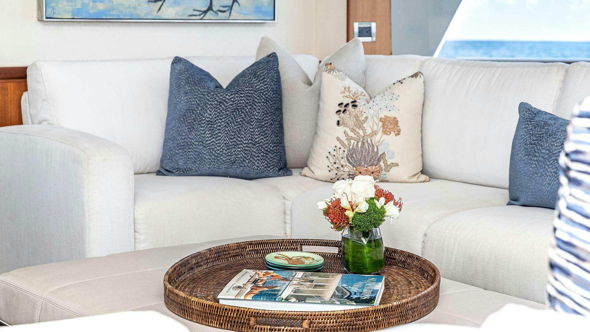 a white couch with pillows and flowers aboard NOW WE KNOW Yacht for Sale