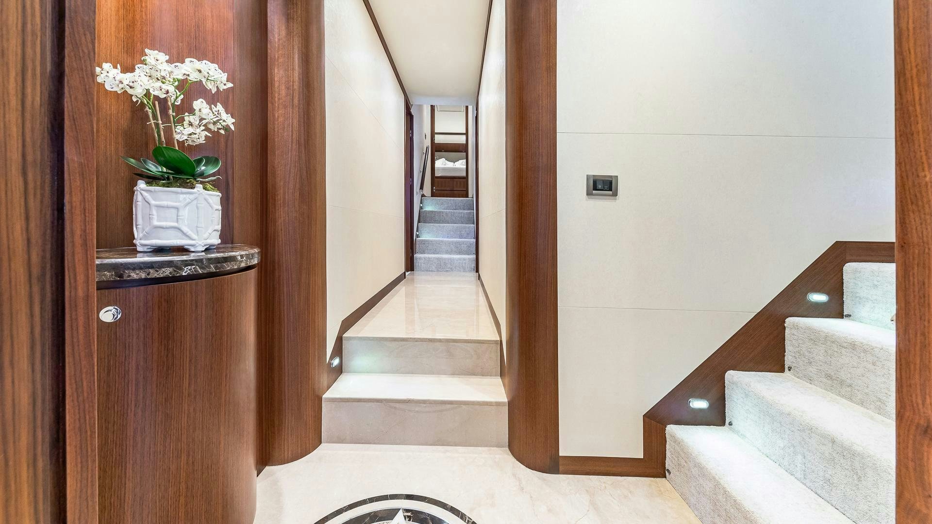 a hallway with a white wall and a white rug aboard NOW WE KNOW Yacht for Sale