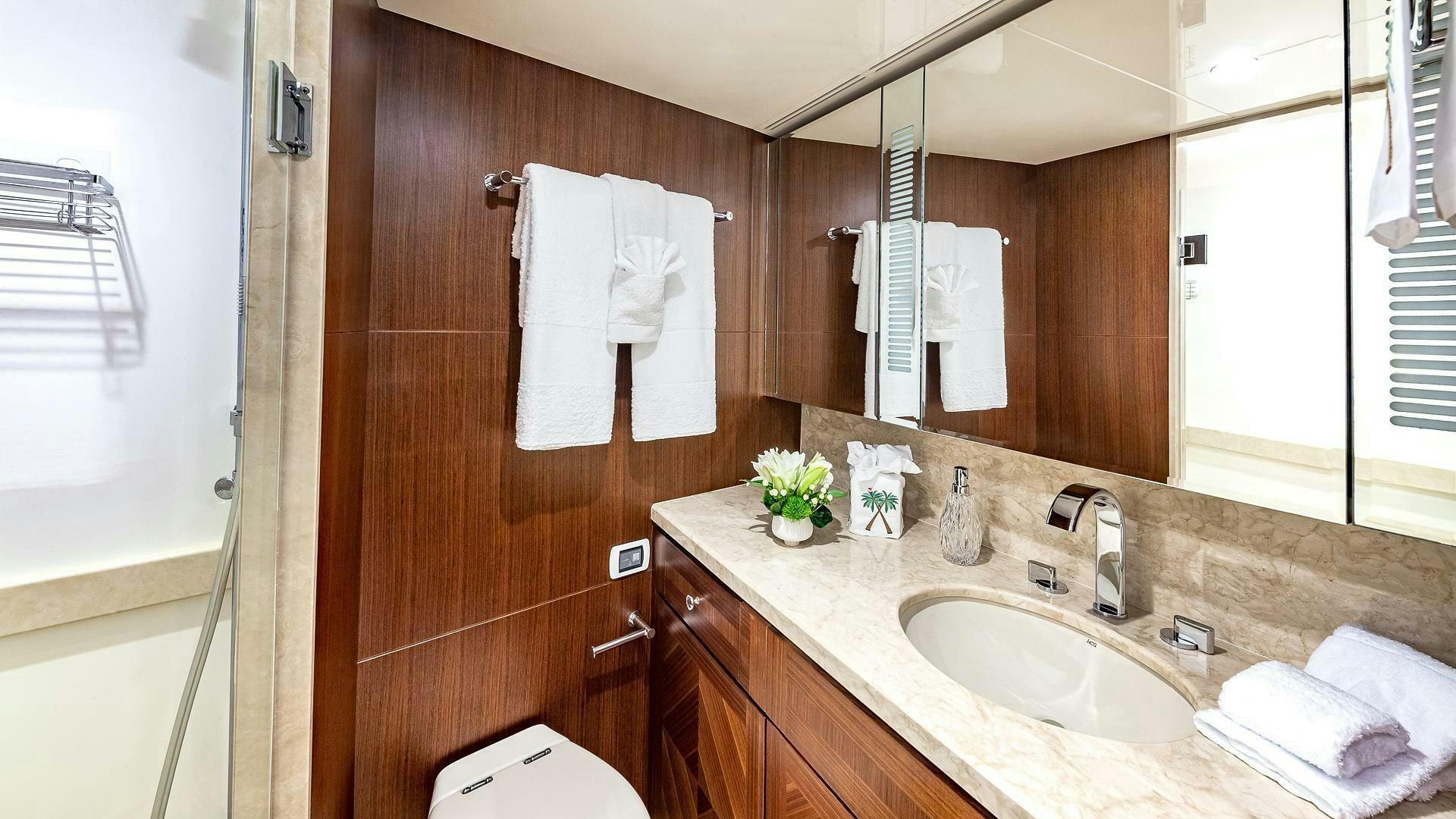 a bathroom with a sink and a mirror aboard NOW WE KNOW Yacht for Sale