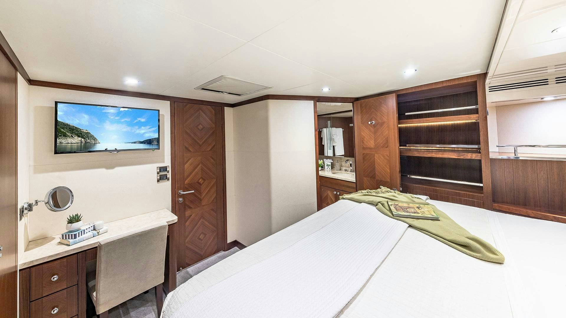 a bedroom with a bed and a desk aboard NOW WE KNOW Yacht for Sale