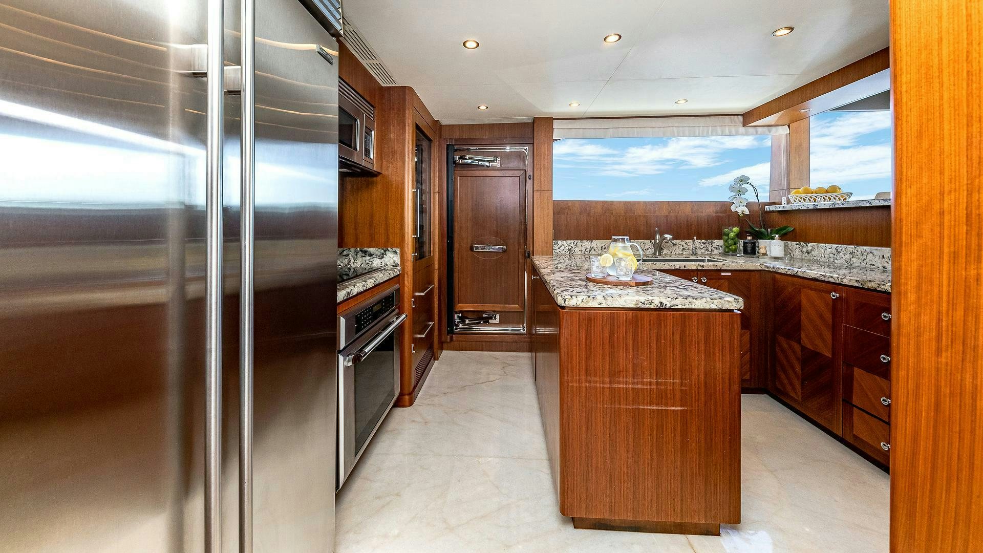 a kitchen with wooden cabinets aboard NOW WE KNOW Yacht for Sale