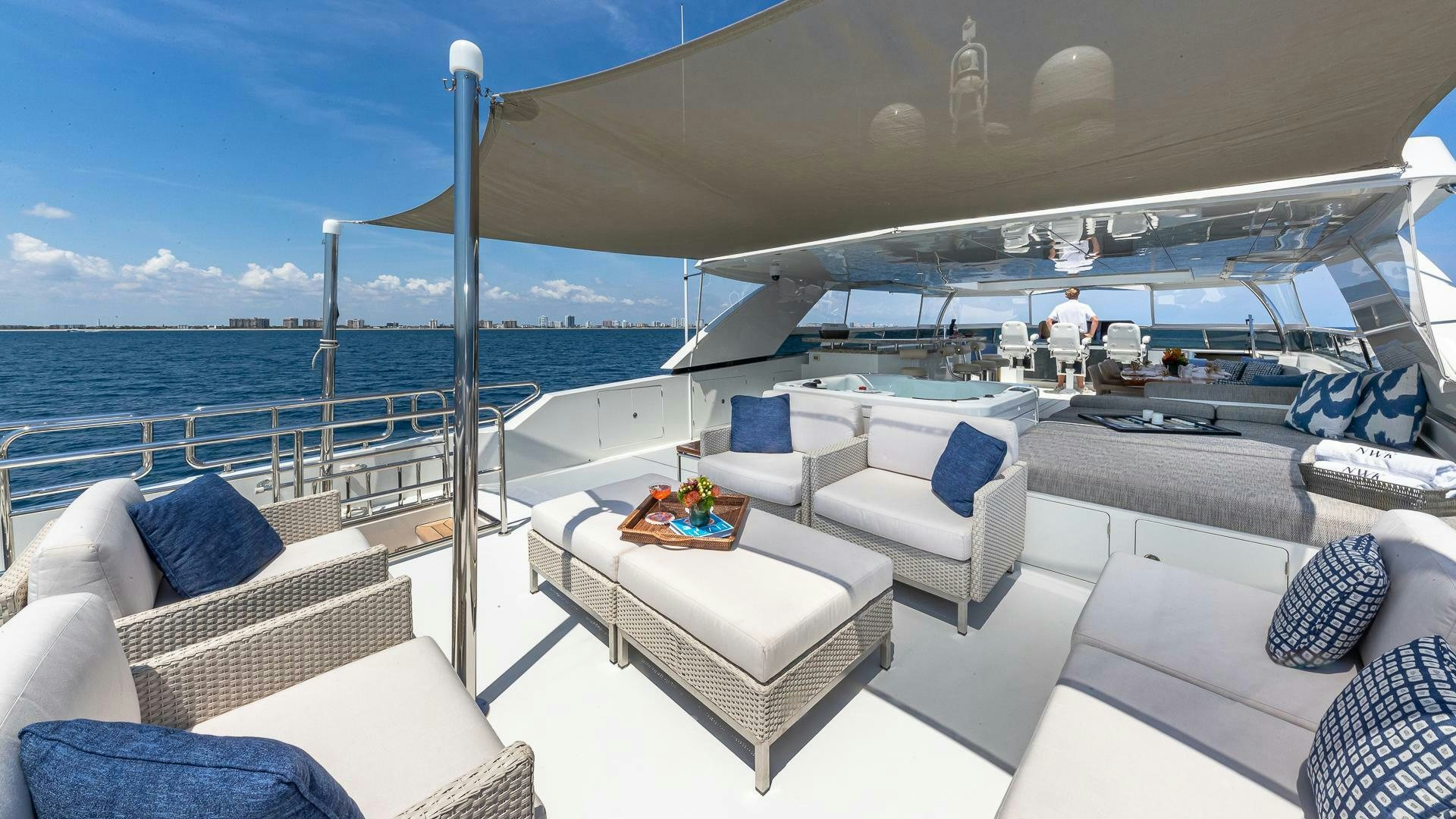 a large white lounge chair on a boat with a large body of water and a large blue sky aboard NOW WE KNOW Yacht for Sale