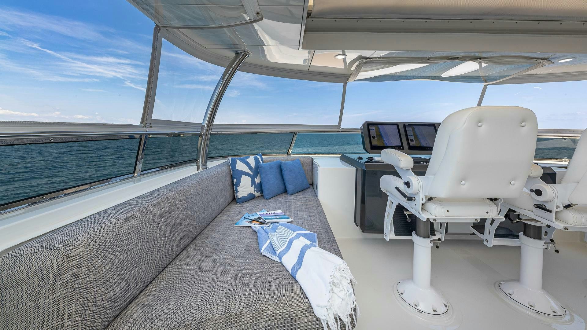 a deck with a chair and a table on it aboard NOW WE KNOW Yacht for Sale