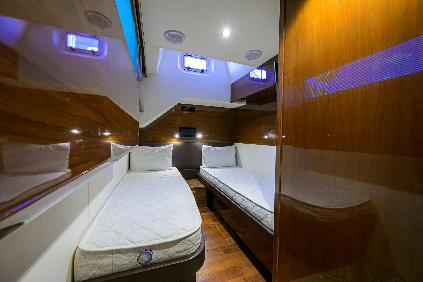 a room with beds and a window aboard TWIST OF FAITH Yacht for Sale