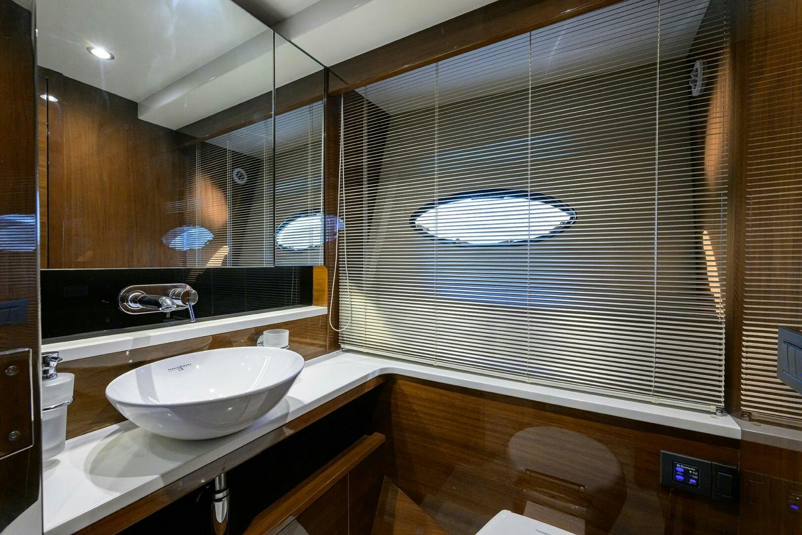 a bathroom with a sink and a large mirror aboard TWIST OF FAITH Yacht for Sale