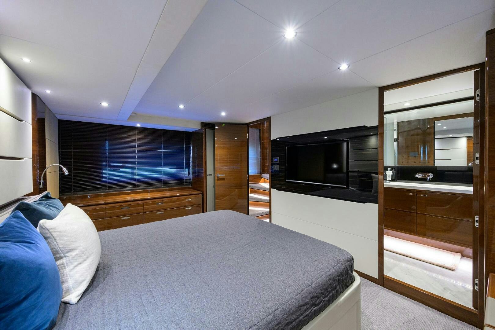 a bedroom with a bed and a tv aboard TWIST OF FAITH Yacht for Sale