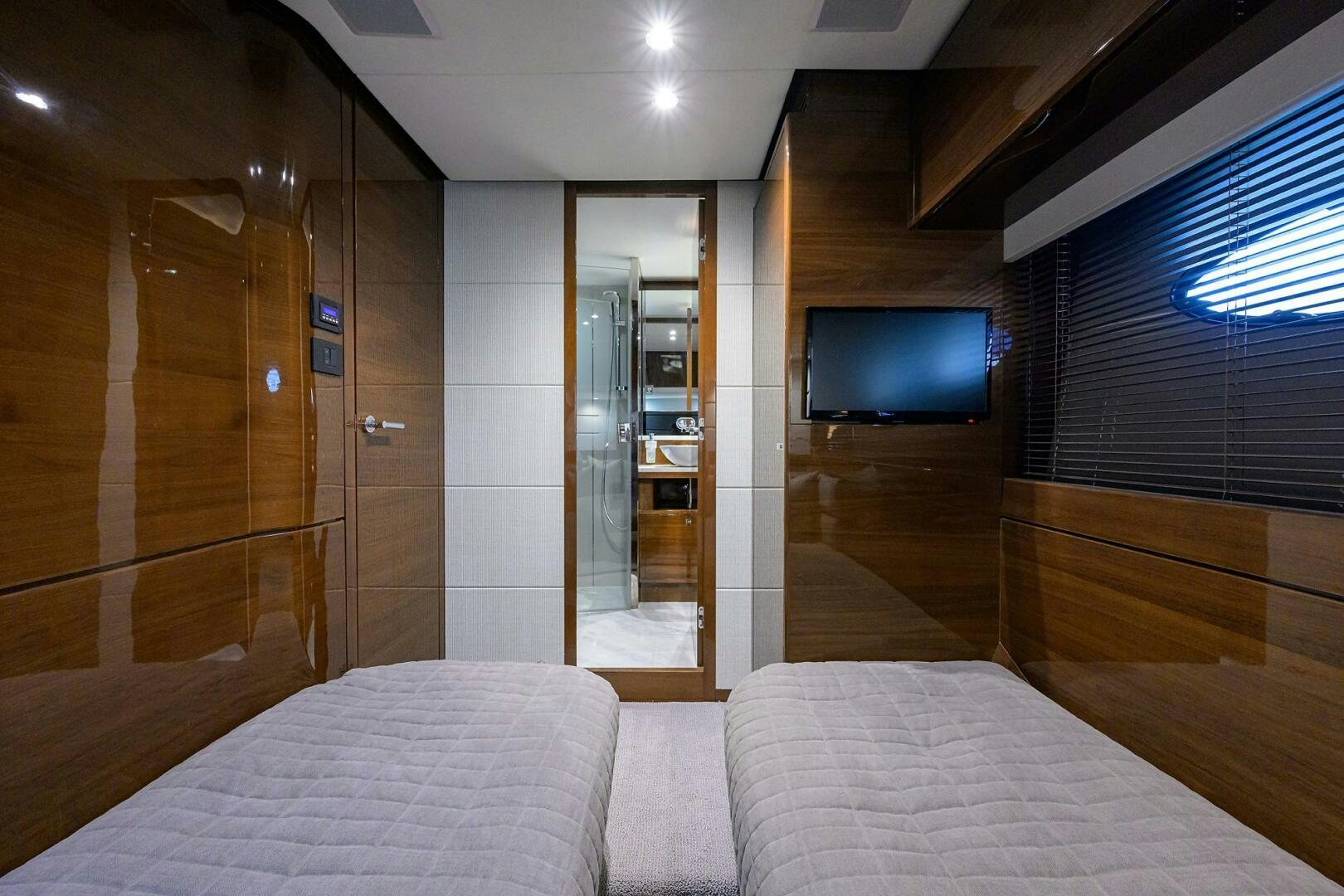 a hotel room with a bed and tv aboard TWIST OF FAITH Yacht for Sale