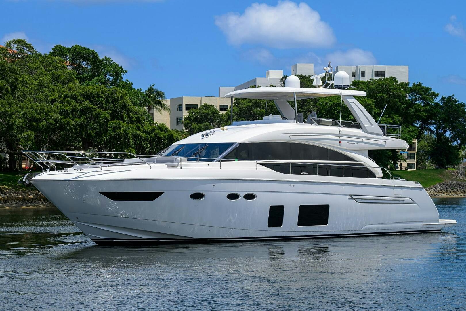 a white yacht in a body of water aboard TWIST OF FAITH Yacht for Sale