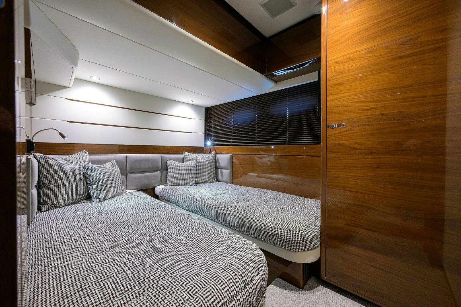 a room with a bed and a wood door aboard TWIST OF FAITH Yacht for Sale