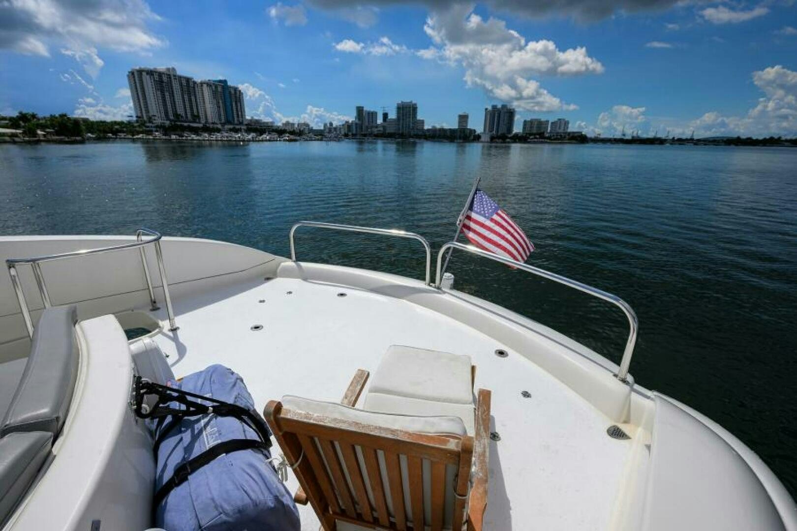 a boat with a flag on the front aboard LIVING THE DREAM Yacht for Sale