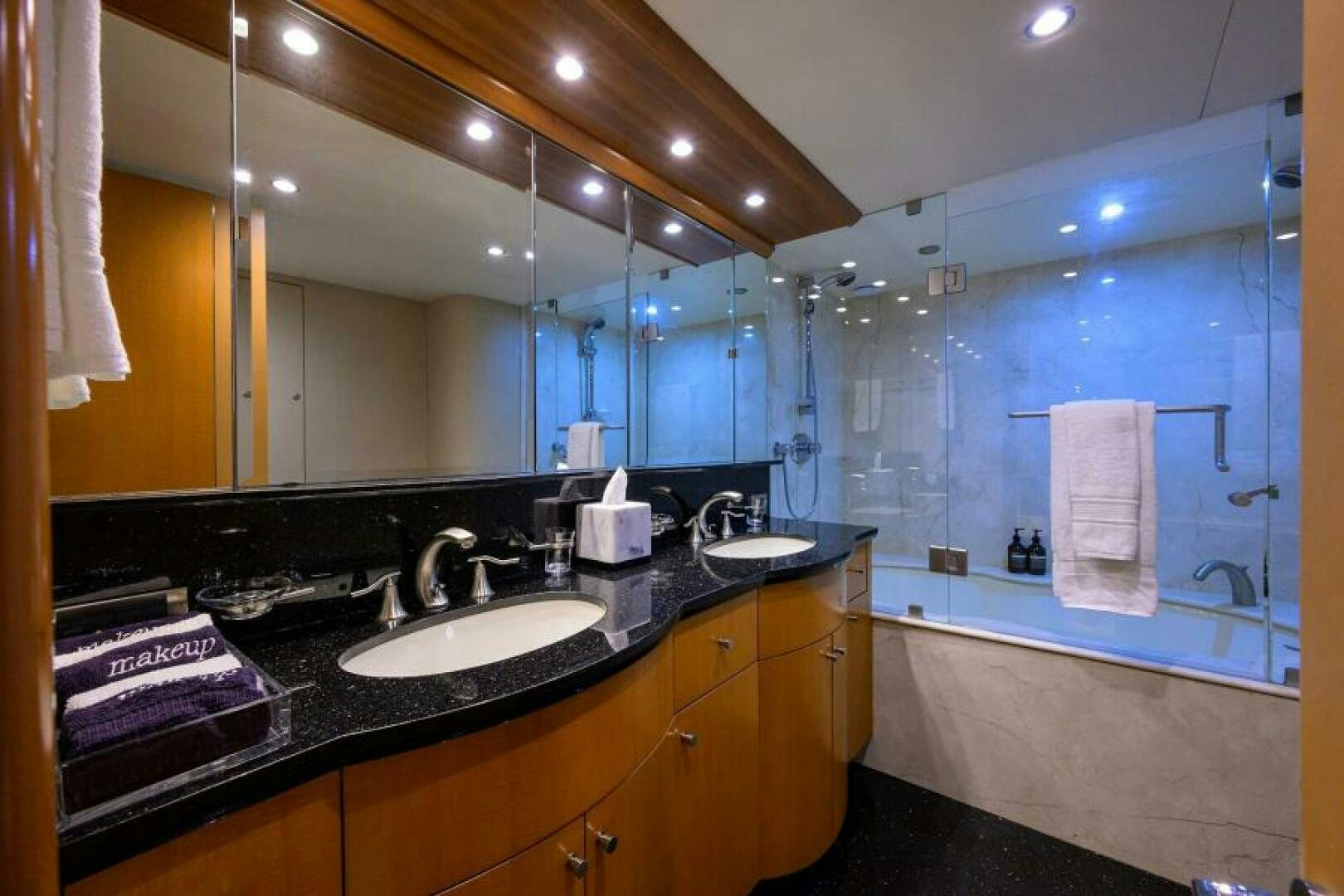 a bathroom with a sink and a large mirror aboard LIVING THE DREAM Yacht for Sale