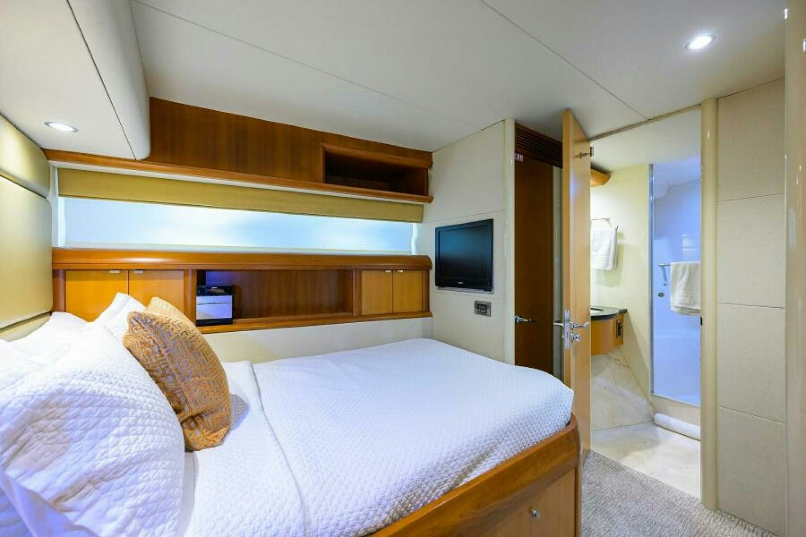 a bedroom with a bed and a television aboard LIVING THE DREAM Yacht for Sale